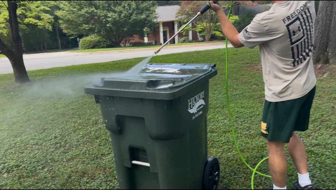 Sparkling clean residential trash bin in a driveway